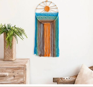 Detail of bohemian sunrise wall hanging featuring colorful tiered cotton rope fringes