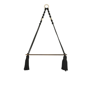 Bohemian black macrame wall hanging shelf with dark wood board and tassel detail