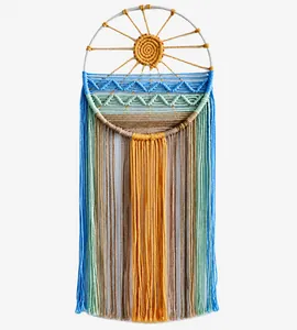 Detailed view of handmade sunrise tapestry with woven cotton rope and long fringe tassels