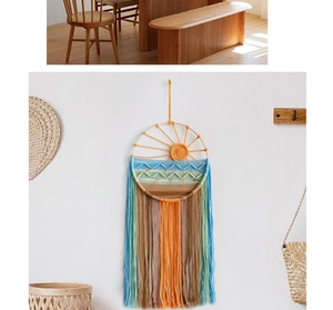 Detail of sunrise macrame wall hanging with sunset woven waves and long tassels décor
