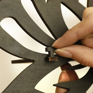 Detail showing the assembly of black wooden flower rack with interlocking T-shaped joint