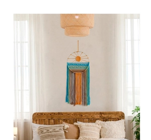 Detailed view of woven sunrise tapestry with colorful long fringes in a bedroom setting