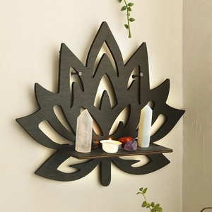 Detailed view of black lotus wooden crystal display shelf on a beige minimalist wall