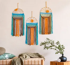 Detailed close-up of three handmade macrame wall hangings with boho fringe and sun patterns
