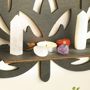 Detailed set of natural white crystal prisms and tumbled healing stones with a tea candle