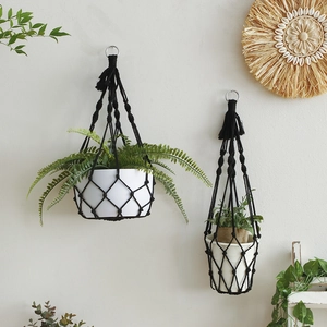 Close-up of black bohemian macrame plant hangers with textured woven patterns