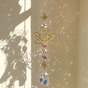 Golden lotus suncatcher detail with crystal beads casting rainbow light on walls