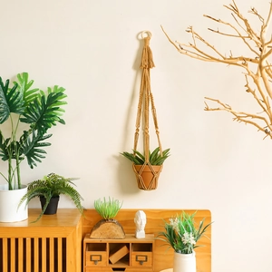 Handmade mustard yellow macrame plant hanger with tassel for bohemian home wall decor
