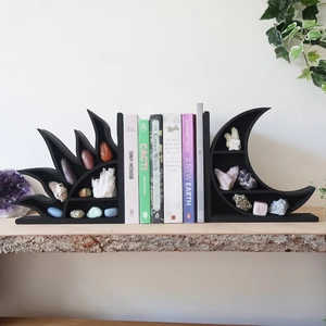 Detail of wooden crescent moon and sun shelf displaying crystals on a rustic wood base