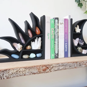 Detail view of moon and sun wood shelves displaying various crystals on a wooden shelf