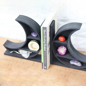 Macro view of moon-shaped wooden shelves for crystal display on a desk