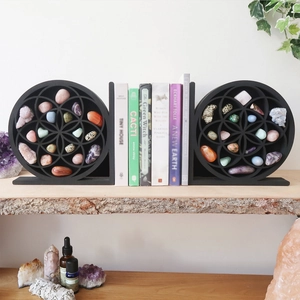 Detail view of black wooden moon shelves with geometric patterns for crystal storage