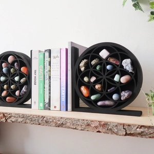 Detail of black Flower of Life wooden shelf with colorful polished crystal stones