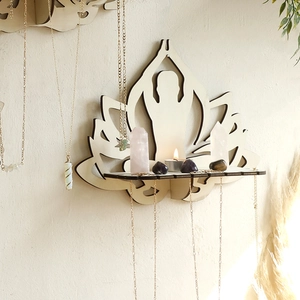 Detail of wooden bohemian yoga wall shelf showing lotus design and jewelry hooks