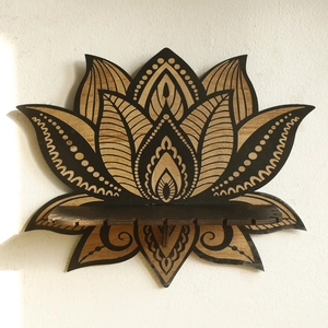 Detail view of lotus-shaped wooden wall shelf with intricate mandala engraving