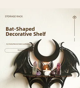 Gothic bat-shaped wooden wall shelf for crystals and candles in a home decor setting