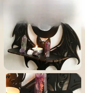 Detail view of gothic bat shaped wooden crystal shelf with moon carvings and tray