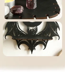 Close-up of black wooden bat-shaped crystal shelf with detailed镂空carvings for gothic decor