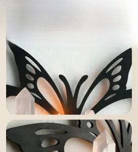 Detail of butterfly metal wall shelf with pink crystal pillars and warm ambient lighting