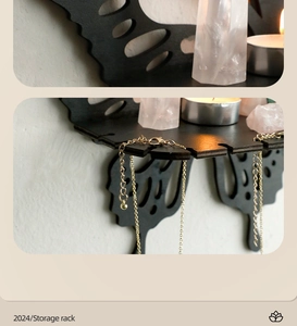 Detail view of black butterfly wooden wall shelf showing necklace hooks and jewelry storage