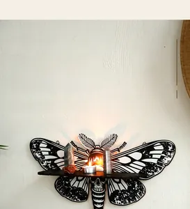 Close-up of wooden moth wall shelf displaying a candle and crystals for home decor