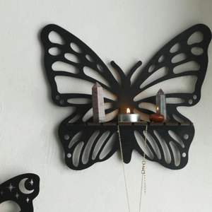 Minimalist black wooden butterfly wall shelf with hollow geometric wings for crystals