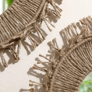 Close-up of bohemian handmade coffee cotton rope weaving and tassel details on mirror