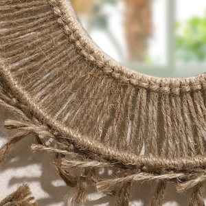 Close-up of Bohemian handmade brown cotton rope weaving and tassel fringe on round wall mirror