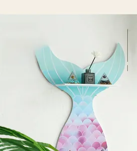 Detail of mermaid tail wooden shelf with blue purple scale patterns and a white ledge
