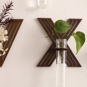 Detail of wooden letter wall planter with glass tube for hydroponic plants