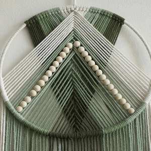 Bohemian macrame wall hanging with forest green cotton ropes and wooden beads decor