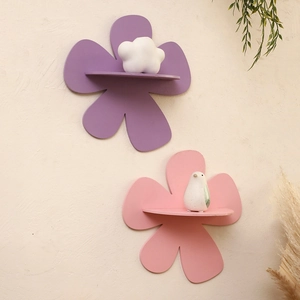 Detail view of flower-shaped wooden shelves in purple and pink for home wall decoration