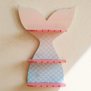 Detail of three-tier mermaid tail wall shelf with pink to blue gradient and scale patterns