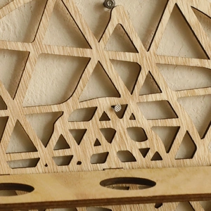 Minimalist round wall mounted wooden planter with geometric laser cut triangle patterns