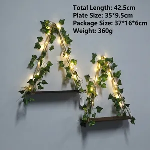 Detail of 2-tier wooden bohemian shelf with ivy vines and LED string lights, 42.5cm long