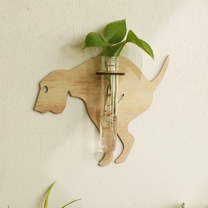 Detail of wooden labrador plant holder with glass hydroponic tube on white wall