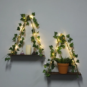 Detail of wooden wall shelf with thick hemp rope, ivy vine, and warm LED light strings