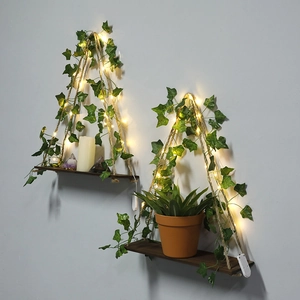 Close-up of bohemian wood shelves with woven hemp rope, ivy leaves, and warm LED lights