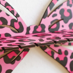Close-up of pink leopard print butterfly wooden shelf with specialized jewelry hanging slots