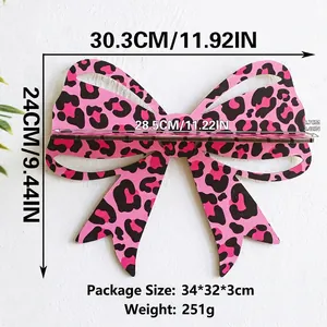 Detail of pink leopard print bow shelf showing 30.3x24cm dimensions on white wall