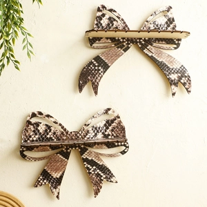 Detail view of wooden bow-shaped wall shelf featuring a realistic brown snakeskin texture