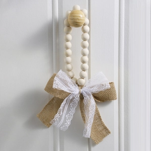 Detailed macro view of handmade wooden bead ring with burlap and lace bow ornament