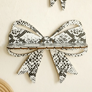 Bohemian bow-shaped wooden wall shelf with black and white snakeskin pattern print