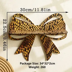 Front view of golden bow wooden crystal wall shelf with snakeskin pattern and dimensions