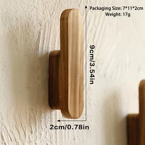 Detailed view of the solid wood wall hook with natural grain on a textured wall