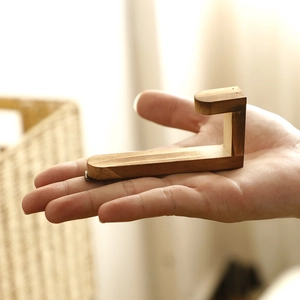 Minimalist solid wood J-shaped wall hook in walnut finish for home decor and storage