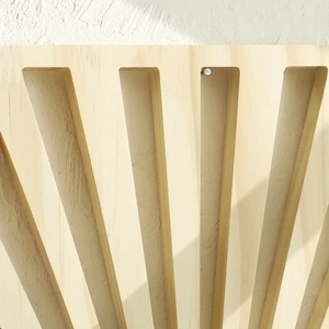 Detailed view of fan-shaped cutout wooden wall shelf with natural texture and geometric shadows