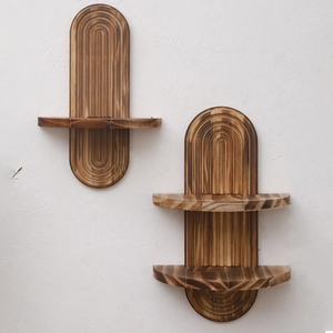 Detail of arched wooden wall shelf with vertical grooves on a white textured wall