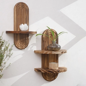 Detail of two-tier rustic charred solid wood wall shelf with oval grooved backplate