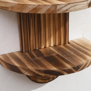 Detail view showing the finger-joint craft and natural grain of the wooden wall shelf